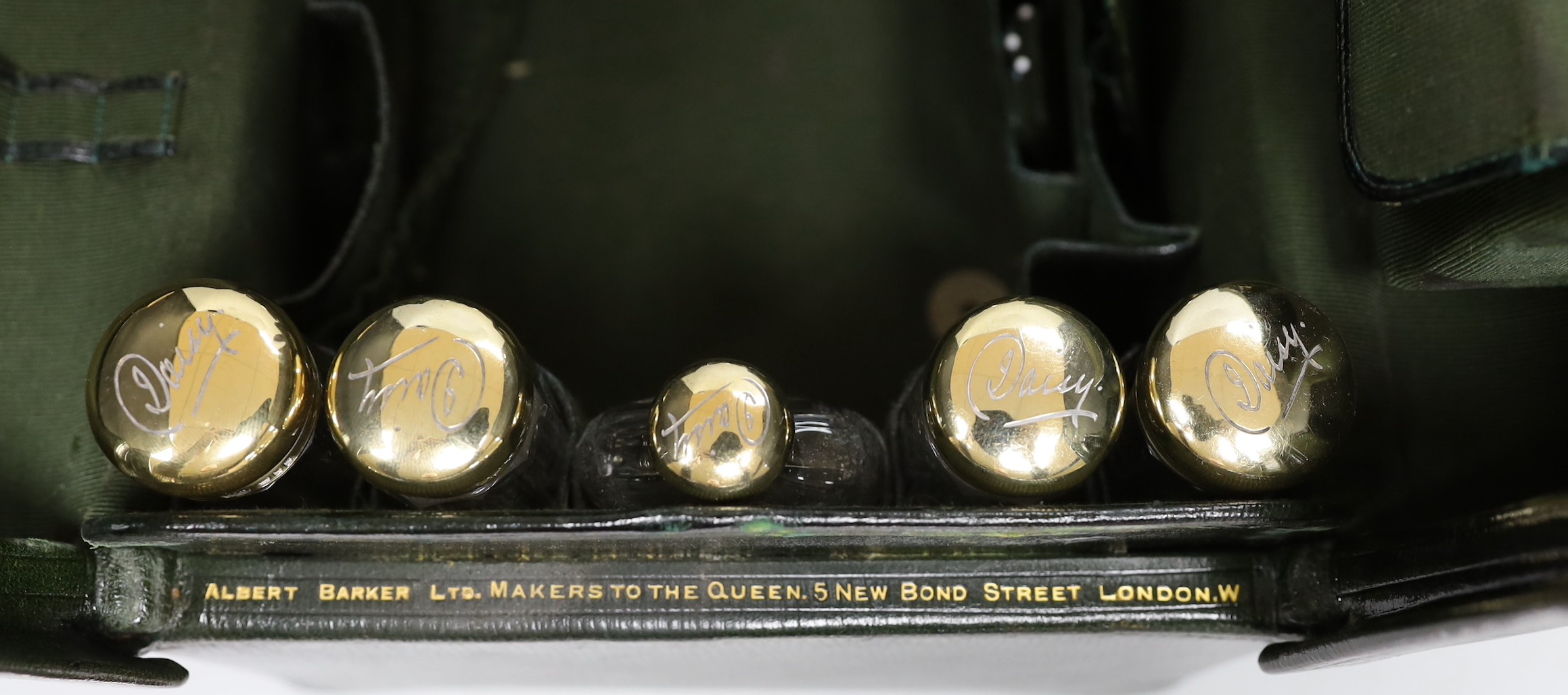 A late Victorian leather Gladstone toilet case, containing eight silver gilt mounted glass toilet jars, all engraved 'Daisy', two makers, London, 1894 & 1898, bag length 33cm.